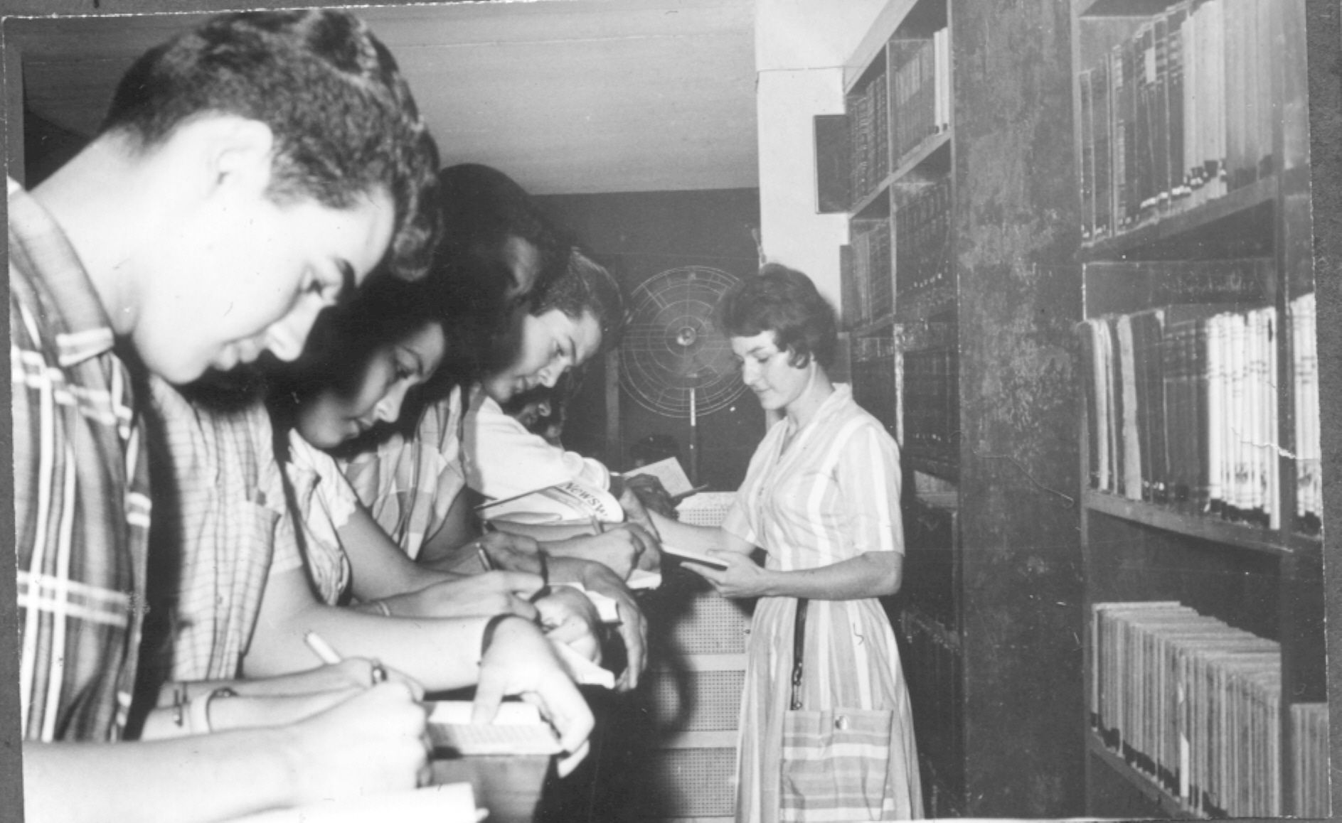 Alumnos en consulta en la biblioteca